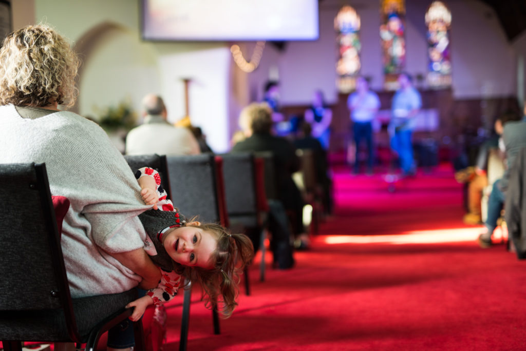 child smiling in church