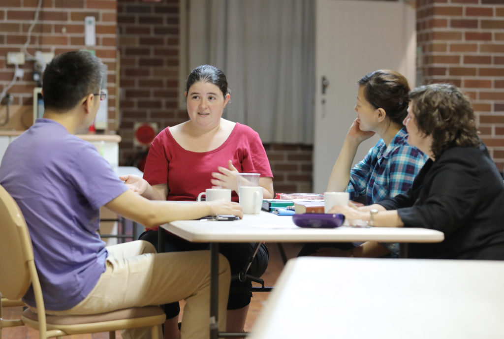 students talking with a teacher